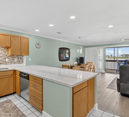 Open-concept living with a spacious kitchen featuring granite countertops and island, flowing seamlessly into your dining and living areas with balcony access.