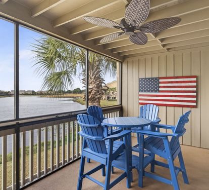 Relax on your private screened balcony with lake views, complete with comfortable dining furniture and a ceiling fan for your comfort.