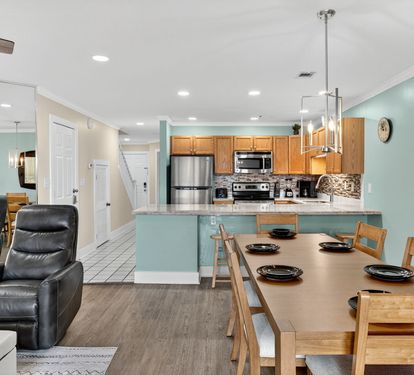 Your open-concept living space seamlessly blends comfort and functionality, featuring a fully equipped kitchen with modern appliances and a welcoming dining area for memorable meals.