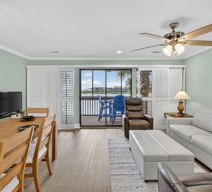 Relax in your bright, airy living space with comfortable seating, dining for six, and sliding doors that open to your private waterfront balcony.