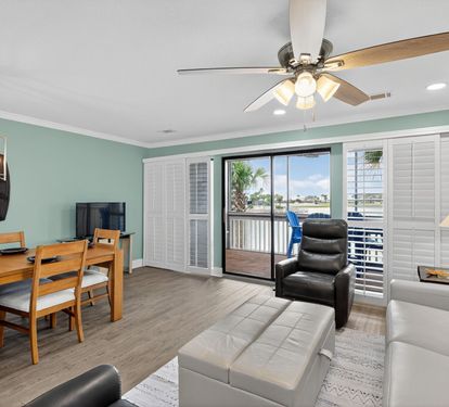 Relax in your modern living space with coastal views from your private balcony, complete with comfortable seating and dining area for memorable vacation moments.