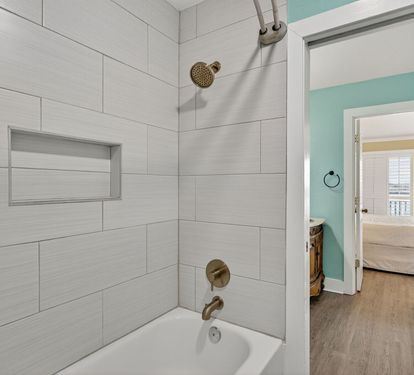 Step into your private bathroom featuring a relaxing tub-shower combo with modern fixtures and soothing neutral tones, connecting seamlessly to your bedroom retreat.