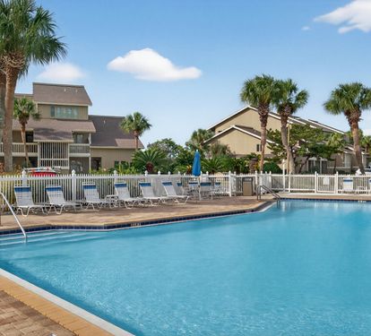 Take a refreshing dip in the crystal-clear pool surrounded by tropical palms and comfortable lounge chairs for the perfect vacation relaxation.