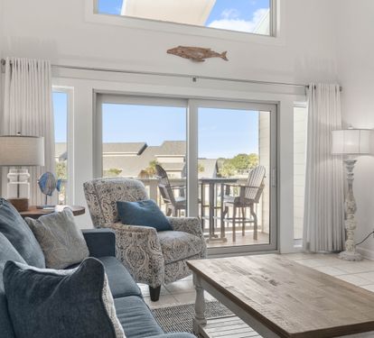 Unwind in your bright living space with cozy seating and direct balcony access to enjoy peaceful outdoor moments.
