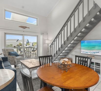Your bright, airy living space features soaring ceilings, comfortable seating, and a dining area perfect for family meals together.