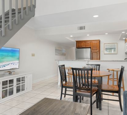 Relax in your bright, open-concept living space with a fully equipped kitchen and cozy dining area perfect for memorable meals.