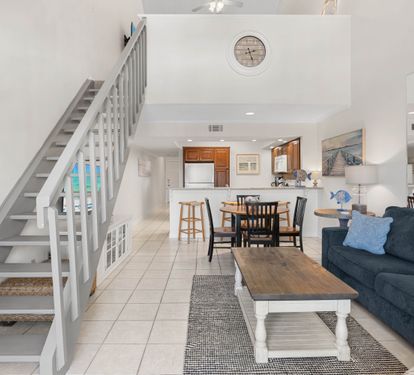 Your open-concept retreat seamlessly blends coastal charm with modern comfort, where you can cook, dine, and relax in one beautiful space.