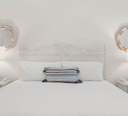 Drift off peacefully in your serene bedroom, with crisp white linens and charming nautical accents creating the perfect coastal retreat.