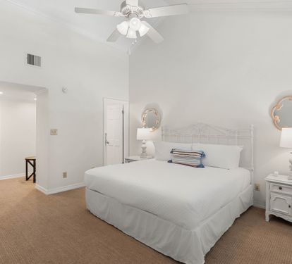 Rest peacefully in your bright bedroom featuring a plush queen bed, charming coastal decor, and convenient en-suite access.
