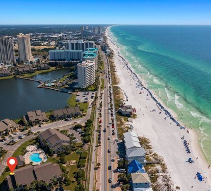 Wake up to breathtaking Emerald Coast views, sugar-white sand, and turquoise waters just steps away. The red marker highlights the convenient location of the unit near beaches, dining, and local attractions.