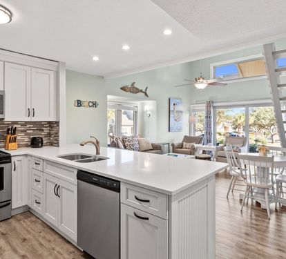 Beautifully updated coastal kitchen with bright open living spaces, stylish beach-inspired décor, and plenty of room to relax and gather after a day in the sun.