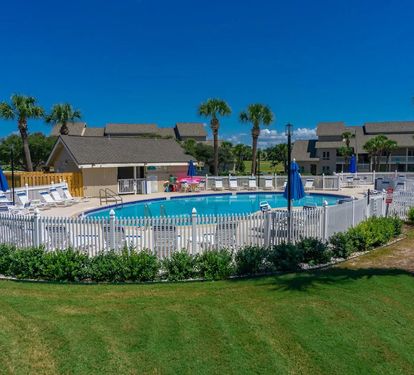 Take a refreshing dip in the sparkling community pool, surrounded by palm trees and relaxing coastal vibes just moments from your vacation retreat.