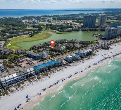 Enjoy a prime location just steps from the sugar-white sand and emerald waters, with the red marker highlighting the convenient location of the unit near the beach and resort amenities.