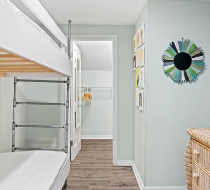 Fun second-floor bunk room featuring twin-over-twin bunk beds, coastal décor, and a cozy space perfect for kids, teens, or extra guests during your beach getaway.