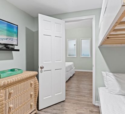 Cozy bunk room featuring twin-over-twin bunk beds, coastal touches, and a comfortable space perfect for kids, teens, or additional guests.