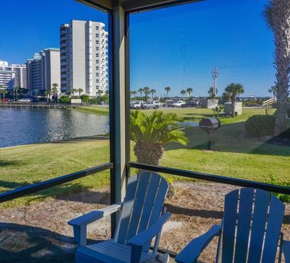 Relax on the screened patio with Adirondack chairs and enjoy peaceful lake views, swaying palms, and a glimpse of the Gulf just beyond. A perfect spot for morning coffee or evening sunsets.