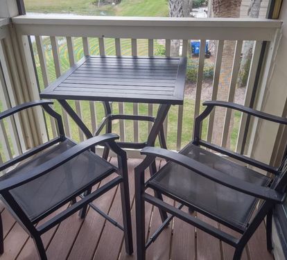 Private balcony with a bistro table and high-top chairs—perfect for sipping morning coffee or enjoying a peaceful evening breeze with a view.