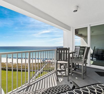 Your private balcony offers stunning oceanfront views while you relax in comfortable seating, watching beach life unfold below.