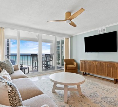 Unwind in your stylish living room where ocean views frame your relaxation time through floor-to-ceiling windows.