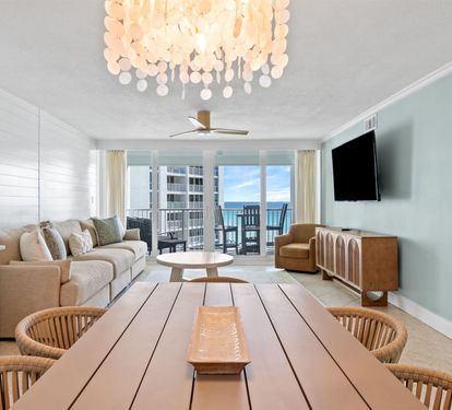 Relax in your stylish living space featuring coastal-inspired decor, comfortable seating, and a spectacular balcony view.