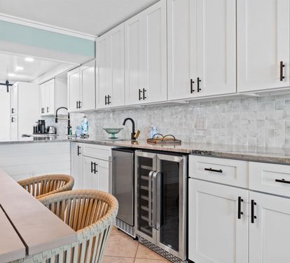 Step into your fully equipped kitchen with sleek white cabinetry, granite counters, and modern appliances perfect for preparing memorable meals together.