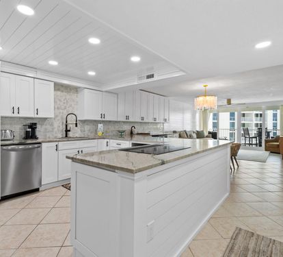 Cook your favorite meals in this stunning modern kitchen featuring granite countertops, stainless steel appliances, and abundant storage space.