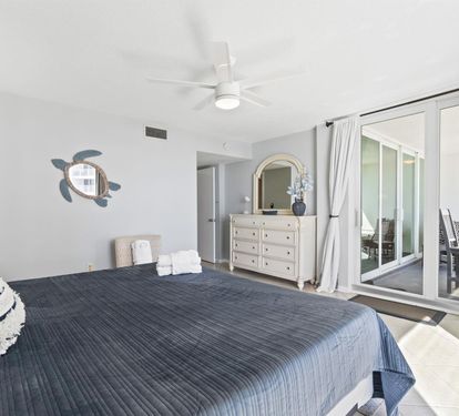 Unwind in your serene bedroom featuring coastal touches, premium linens, and private balcony access for peaceful mornings.