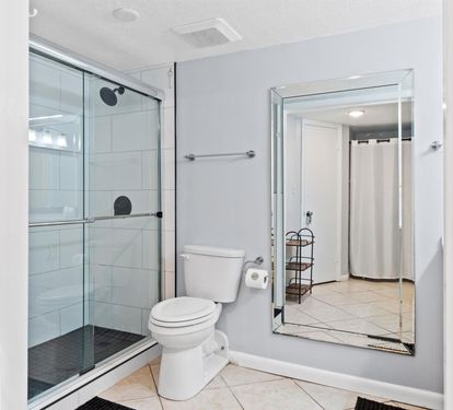 Step into your private sanctuary with a spacious glass-enclosed shower, modern fixtures, and elegant tile work that creates the perfect morning retreat.