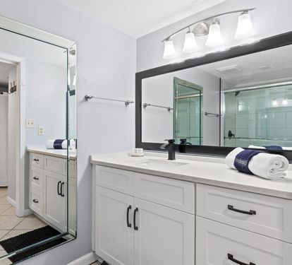 Refresh in your spacious bathroom with dual vanities, bright lighting, and modern amenities thoughtfully arranged for your comfort.