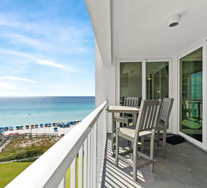 Your private balcony with dining table overlooks pristine white sand beaches and turquoise waters—perfect for morning coffee or sunset dinner.