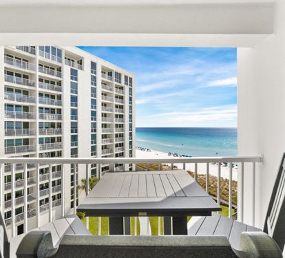 Your private balcony offers breathtaking ocean views where you can dine al fresco while watching waves meet pristine white sand below.