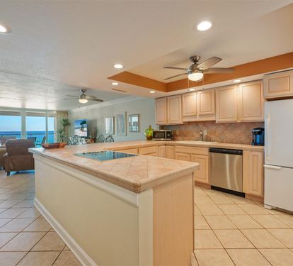 Prepare your favorite meals in this spacious kitchen featuring granite countertops and stunning ocean views beyond.