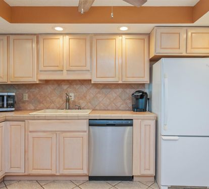 Prepare your favorite meals in this fully-equipped kitchen featuring modern appliances and ample cabinet space for all your culinary adventures.
