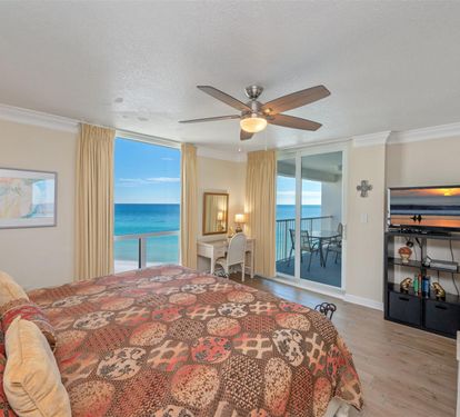Wake up to breathtaking ocean views from your comfortable bedroom, where the ceiling fan keeps you cool and sliding doors lead to your private balcony.