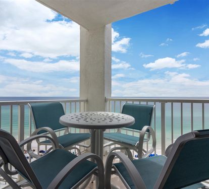 Sip your morning coffee while watching waves crash below from this oceanfront balcony with comfortable seating.