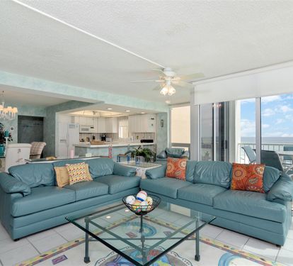 Settle into your spacious oceanfront living room, where coastal blues meet comfort and stunning sea views await beyond your private balcony.