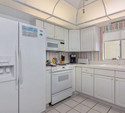Your fully-equipped kitchen invites culinary adventures with modern appliances and cheerful accents—perfect for preparing meals together.