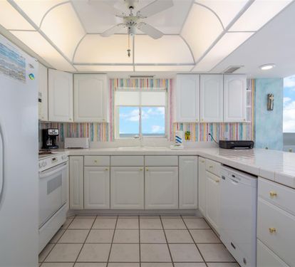 Step into your bright, fully-equipped kitchen where ocean views inspire culinary adventures and every meal becomes memorable.