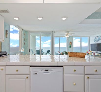 Prepare your favorite meals in this bright, beachfront kitchen while soaking in stunning ocean views through floor-to-ceiling windows.