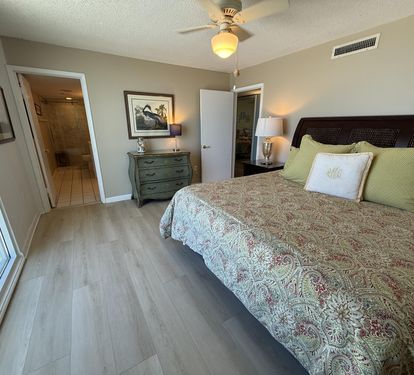 Drift into peaceful sleep in your elegant bedroom with coastal charm, complete with a ceiling fan and en-suite bathroom access.
