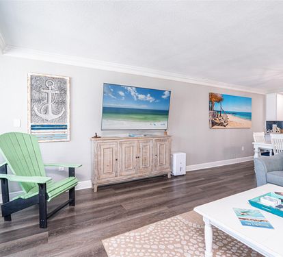 Relax in your coastal-themed living space where ocean artwork and mint green furnishings create the perfect beach house ambiance for your stay.