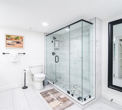 Indulge in your private spa-like retreat with luxurious marble shower, elegant vanity, and thoughtful storage—your perfect sanctuary.