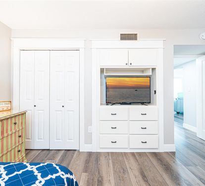 Unwind in this bright bedroom featuring built-in entertainment center and cozy seating while you enjoy your favorite shows.