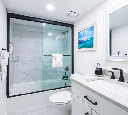 Step into your pristine bathroom featuring a luxurious marble-tiled shower and modern fixtures for your ultimate comfort.