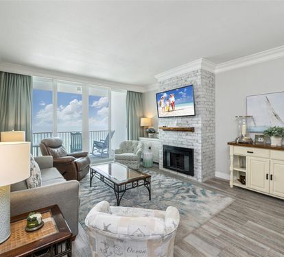 Unwind in your elegant living room with stunning ocean views, cozy fireplace, and coastal-themed décor perfect for relaxing after beach days.