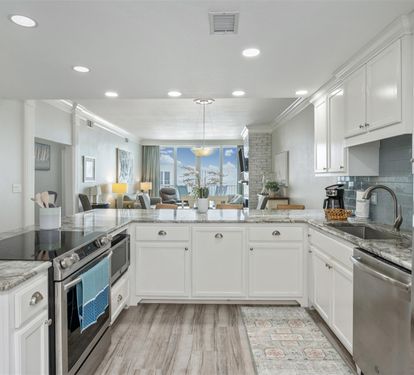 Your dream kitchen awaits with gleaming granite counters, white cabinetry, and stainless steel appliances perfectly positioned for memorable meal prep.