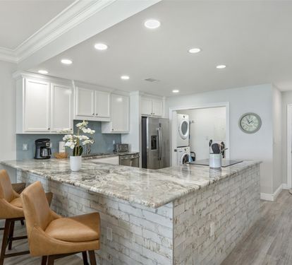 Your gourmet kitchen features marble countertops, premium appliances, and a spacious island perfect for morning coffee and meal prep.