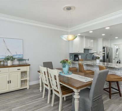 Your bright, open-plan kitchen and dining space features granite counters, coastal décor, and everything needed for memorable meals together.
