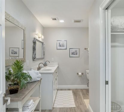 Refresh in your elegant bathroom with dual sinks, thoughtful decor, and a peaceful atmosphere perfect for unwinding.