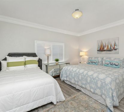 Wake up refreshed in your peaceful bedroom featuring two comfortable beds with coastal-inspired décor and soft natural lighting.